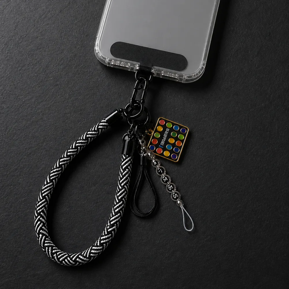 INMERS phone strap attached to a phone — braided rope with charms