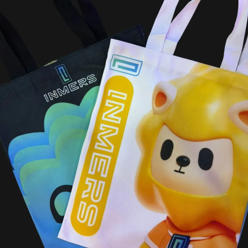 Black and white INMERS tote bags featuring INMERS graphics and the mascot